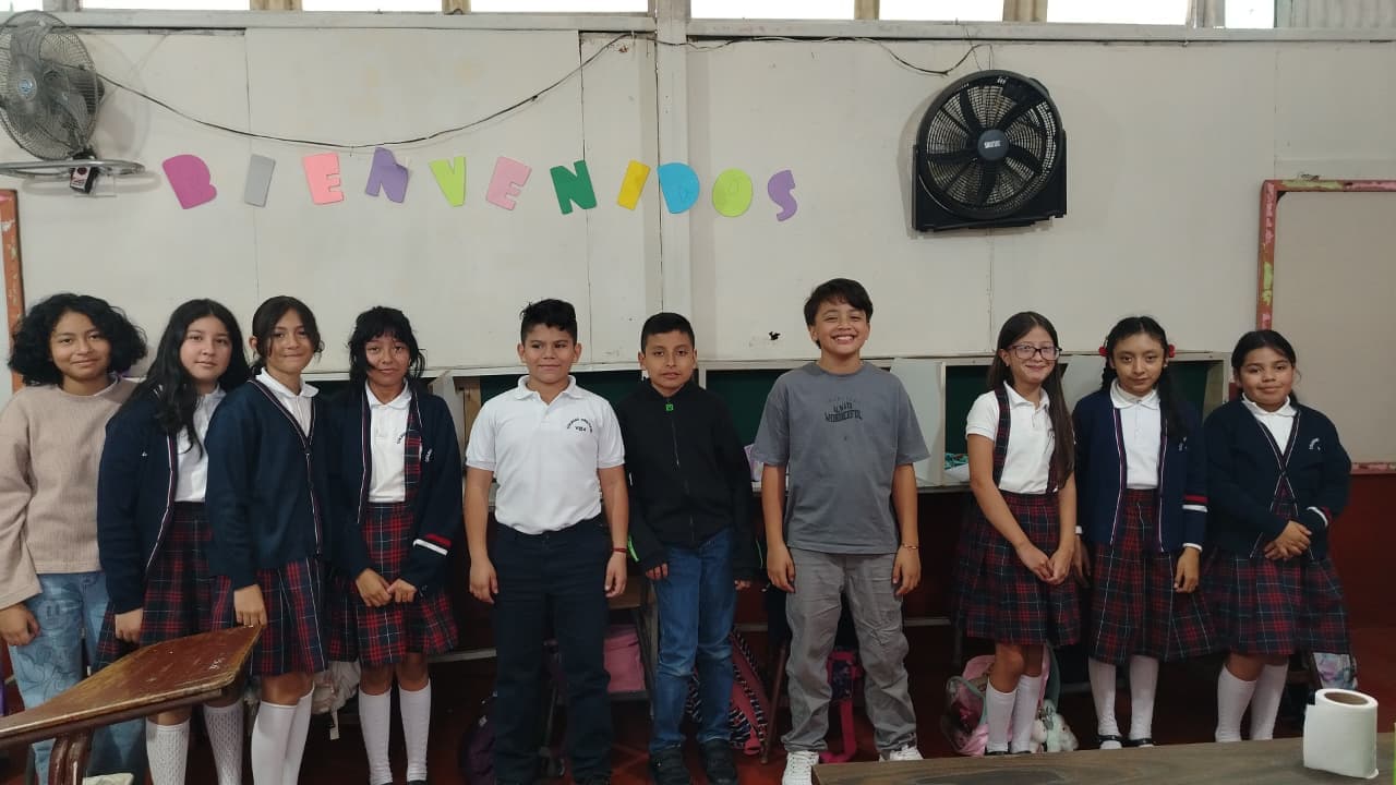 Students standing together in their classroom at Colegio Vida