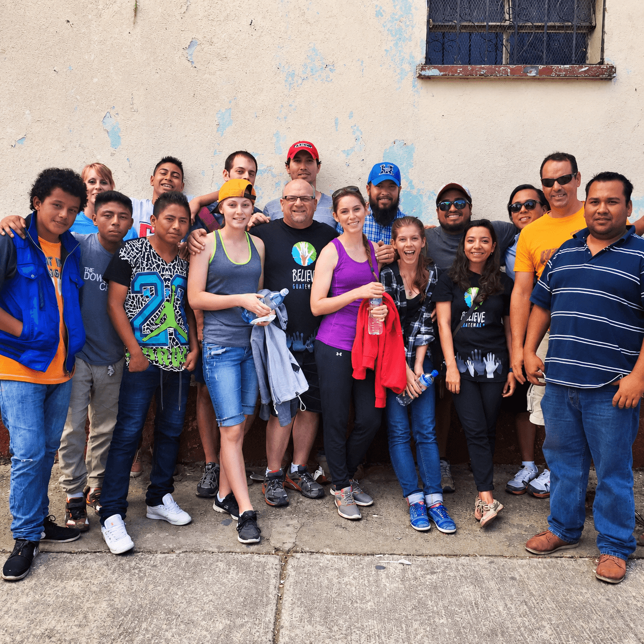 A group of volunteers gathered together outdoors