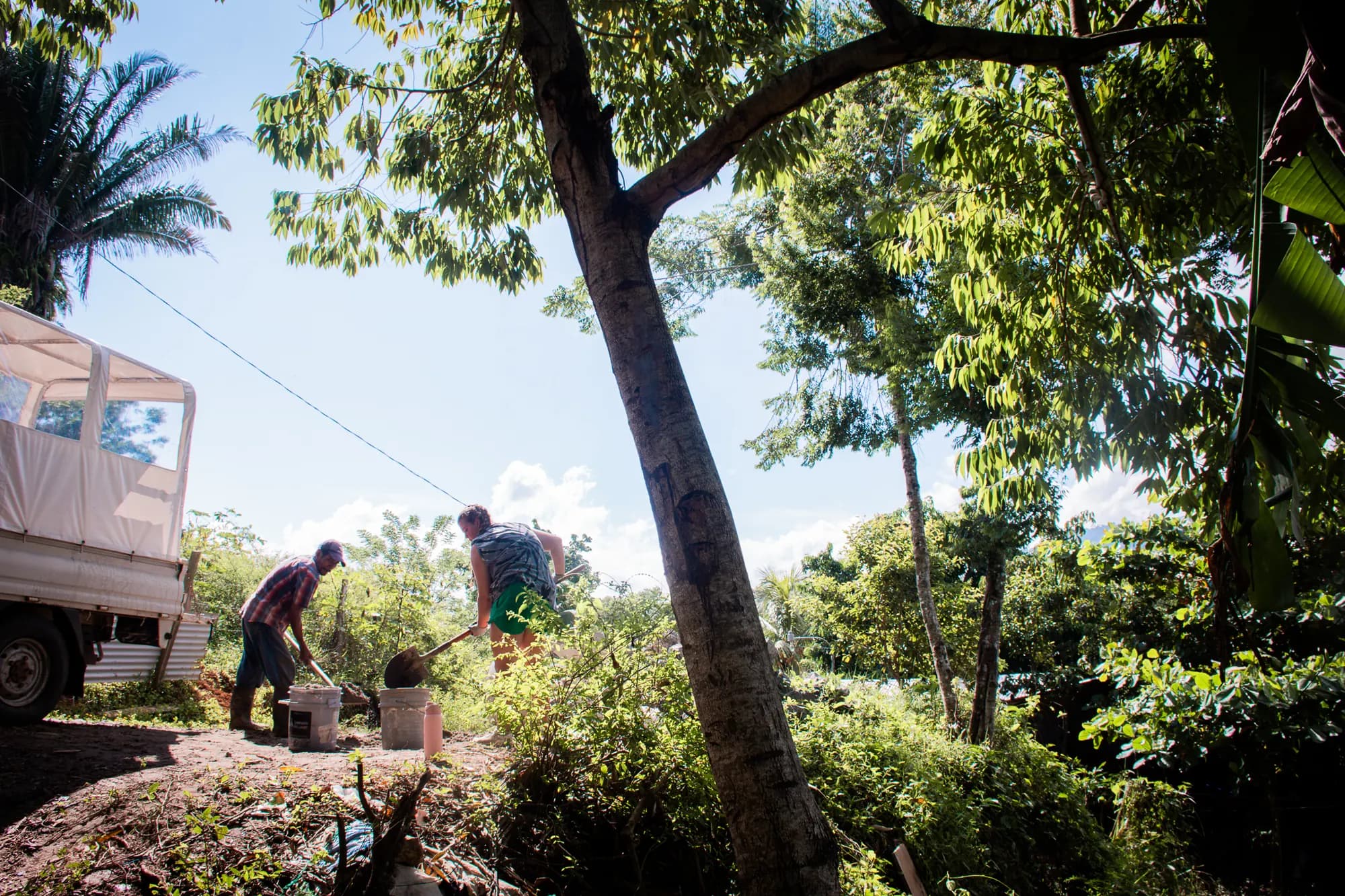 Team members work around a family home during a community project.