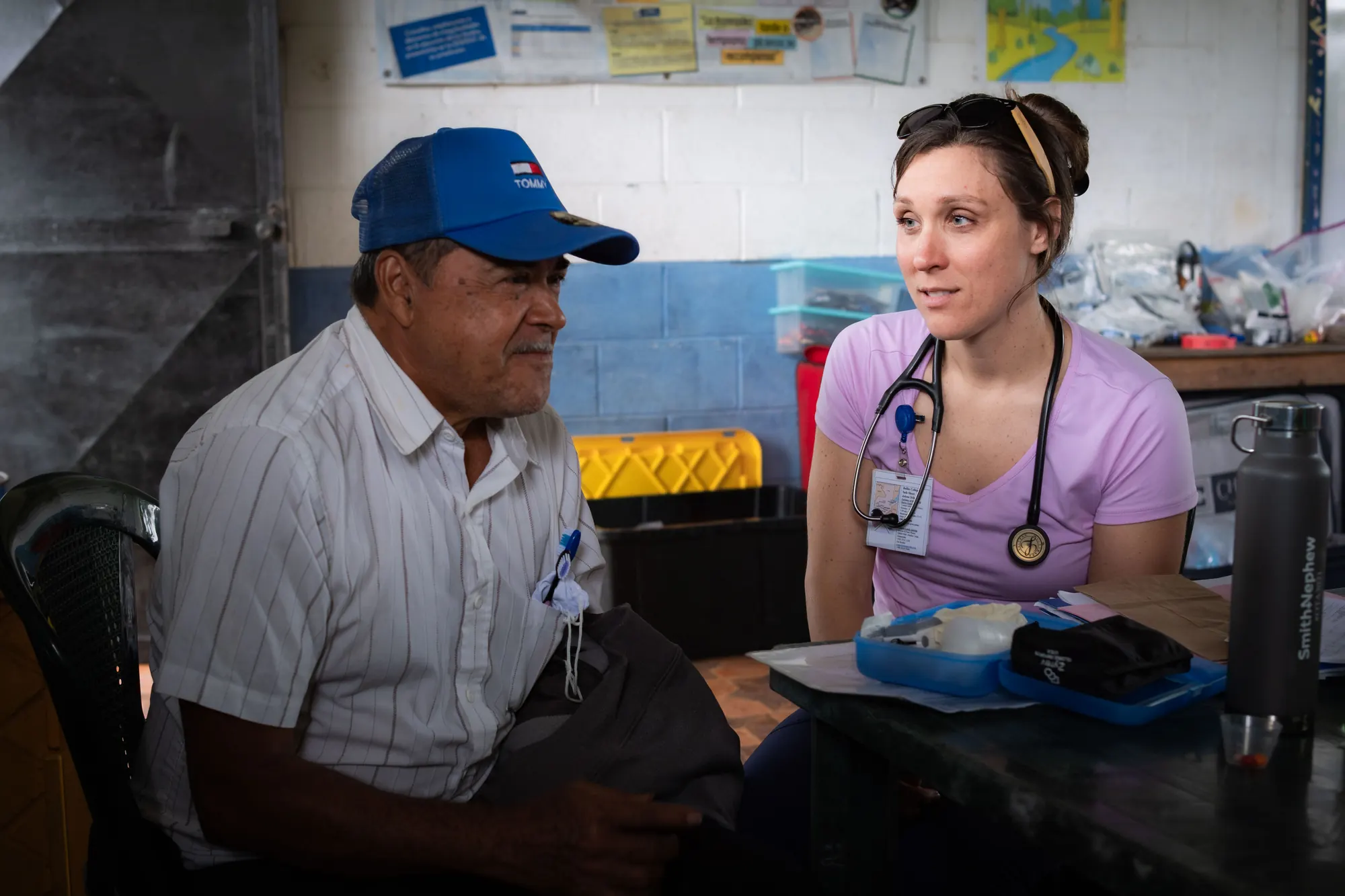 A visiting healthcare volunteer listens to a patient in Guatemala.