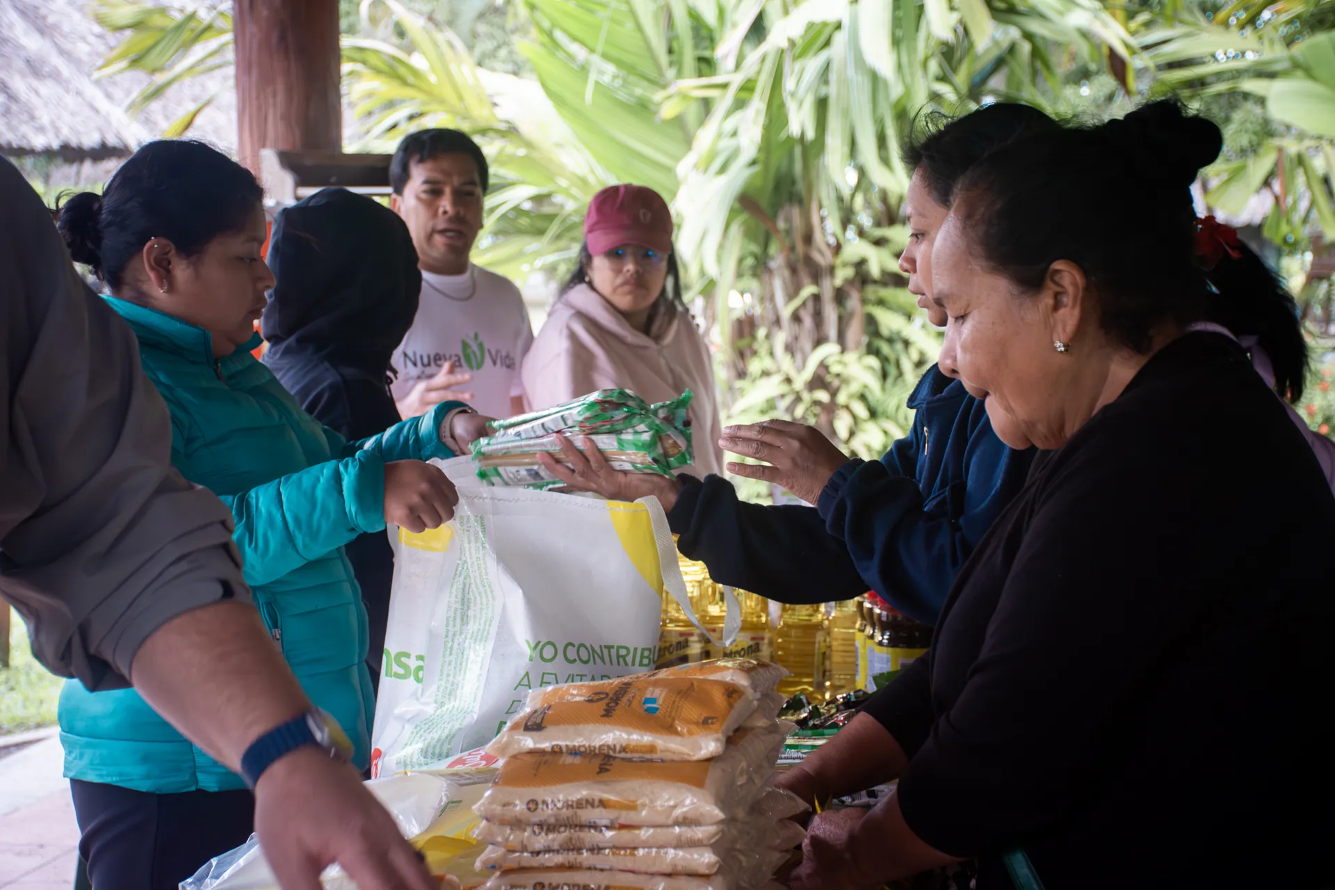 Community partners distribute staple food bags to families in Guatemala.